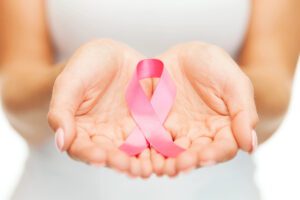 breast cancer awareness pink ribbon in womans hands