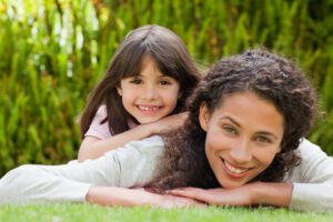 Smiling-Mother-and-Daughter-Outside